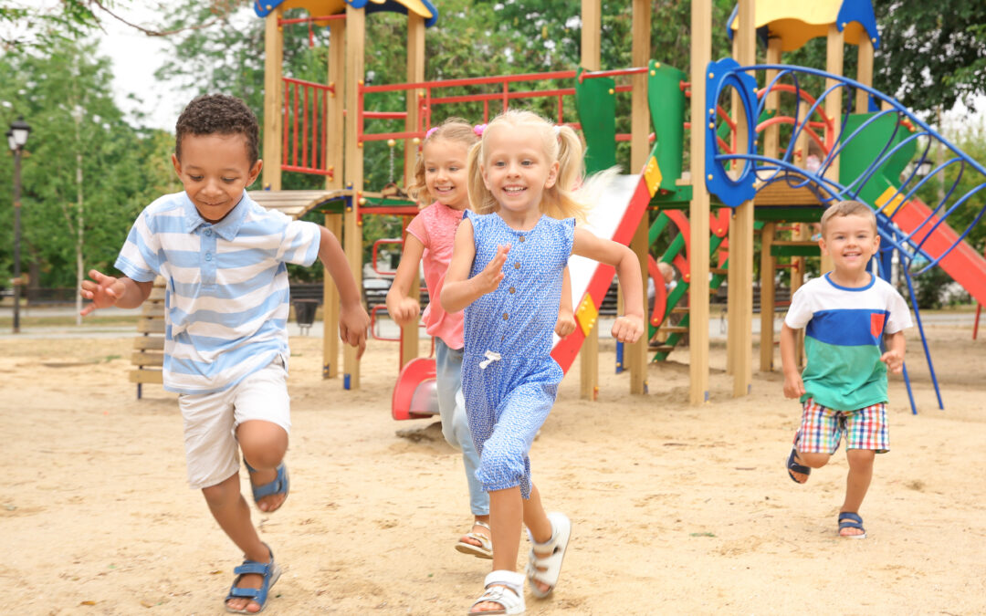 Group of young children running on playground